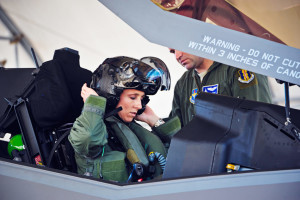 Lt. Col. Christine Mau, 33rd Operations Group deputy commander, puts on her helmet before taking her first flight in the F-35A on Eglin Air Force Base, Fla., May 5, 2015. Mau, who previously flew F-15E Strike Eagles, made history as the first female F-35 pilot in the program. (U.S. Air Force photo/Staff Sgt. Marleah Robertson)