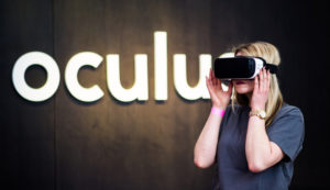 BERLIN, GERMANY - FEBRUARY 24: A woman puts on the Head-Mounted Display Oculus Rift on February 24, 2016 in Berlin, Germany. Facebook presented its Innovation Hub where new technology and ideas were shown. (Photo by Florian Gaertner/Photothek via Getty Images)