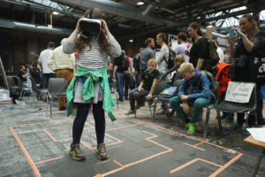 BERLIN, GERMANY - OCTOBER 01:  A young visitor explores a Virtual Reality landscape with VR goggles at the 2016 Berlin Maker Faire on October 1, 2016 in Berlin, Germany. The Maker Faire combines a trade fair with hands-on opportunities and workshops for both children and adults to explore a wide realm of new technologies and do-it-yourself projects.  (Photo by Sean Gallup/Getty Images)