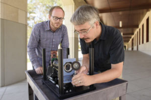 Assistant prof. Gordon Wetzstein and postdoctoral scholar Donald Dansereau with a prototype of the monocentric camera that captured the first single-lens panoramic light fields.