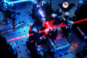 Quantum cryptography. Eye of an observer reflected in a mirror in quantum cryptography apparatus. Quantum cryptography is based on the principle of entanglement, a property of a pair of particles in which a change to one has an instantaneous effect on the other, no matter how far apart they are. Cryptography in this case refers to the encoding of data so that only specified targets can access it. If the sender and the receiver of the data share entanglement then any data is only readable by them alone. This is more secure than existing encryption methods, most of which rely on mathematical algorithms. Photographed at the lab of Anton Zeilinger at Vienna University, Austria.