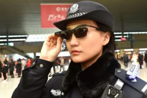 This photo taken on February 5, 2018 shows a police officer wearing a pair of smartglasses with a facial recognition system at Zhengzhou East Railway Station in Zhengzhou in China's central Henan province. Chinese police are sporting high-tech sunglasses that can spot suspects in a crowded train station, the newest use of facial recognition that has drawn concerns among human rights groups. / AFP PHOTO / - / China OUT        (Photo credit should read -/AFP/Getty Images)