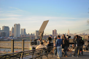 Brooklyn, USA - April 12, 2010: A film crew from Japan films on Brooklyn Heights Promenade overlooking downtown Manhattan in New York City.